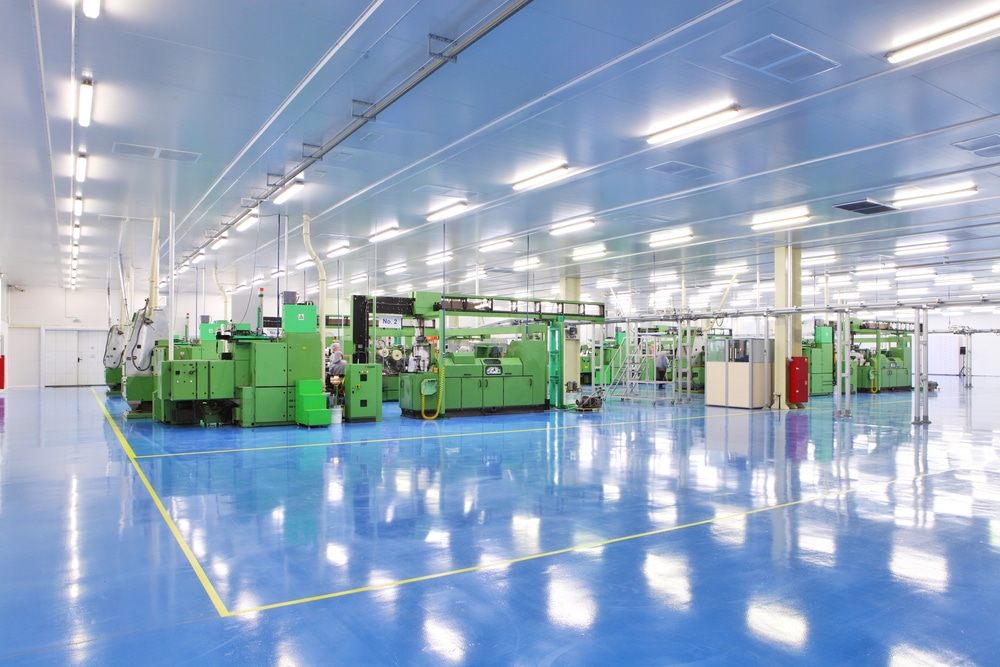 Production floor with a blue resin coating and green machinery